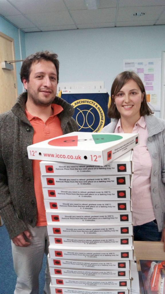 Vice-chair Joel Perez Osses, chair Lucy Collins and a tower of pizza at the SNAME social